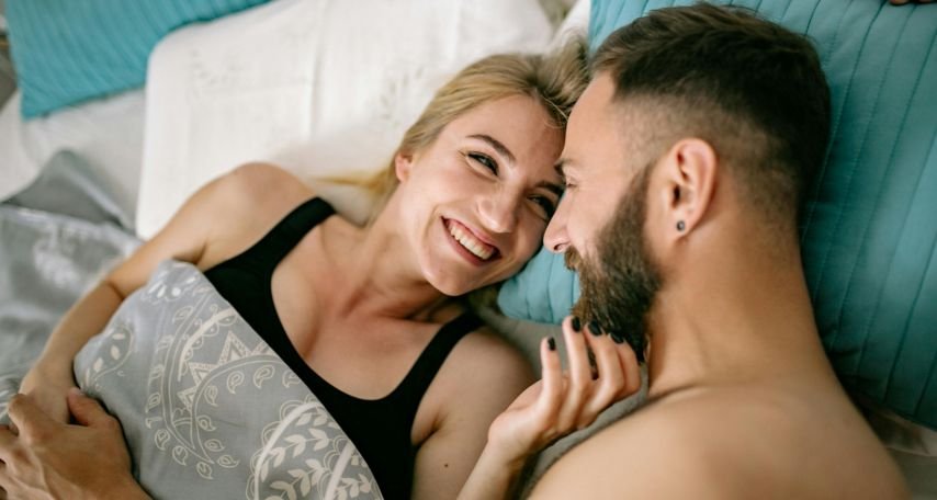 Happy Couple Cuddling in Bed
