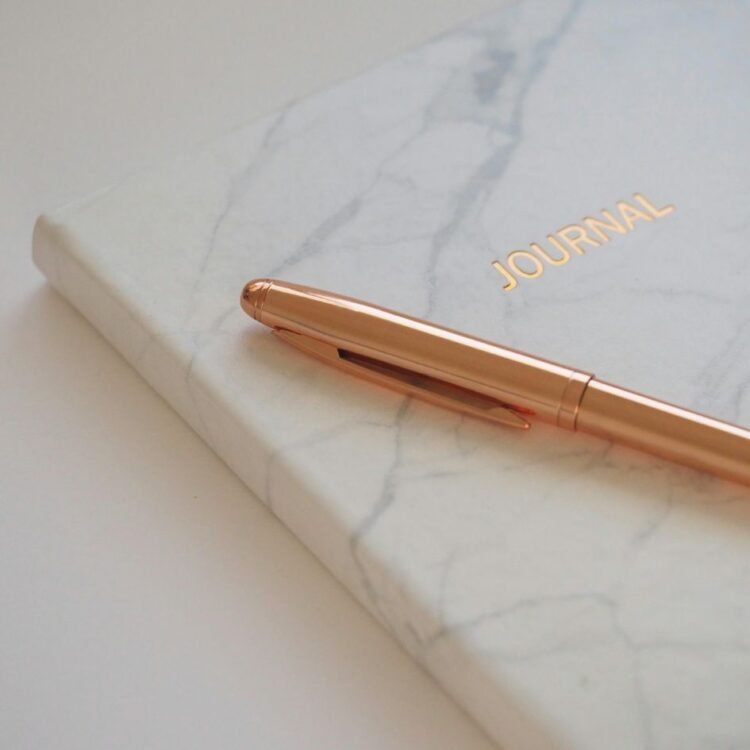 Gold Pen on Journal Book