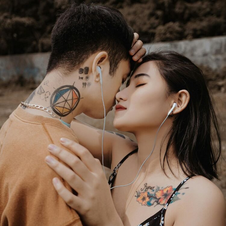 Couple Embracing Each Other while Listening to Music
