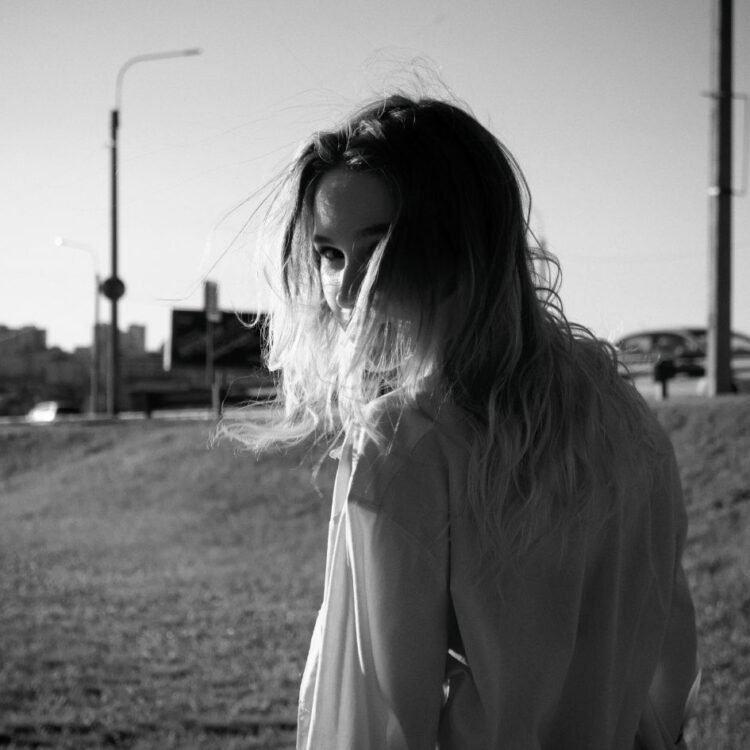 Black and White Photo of a Woman Looking Over Shoulder
