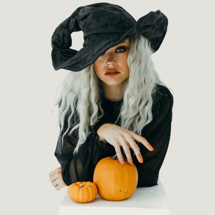 Woman in Black Witch Costume With Two Pumpkins