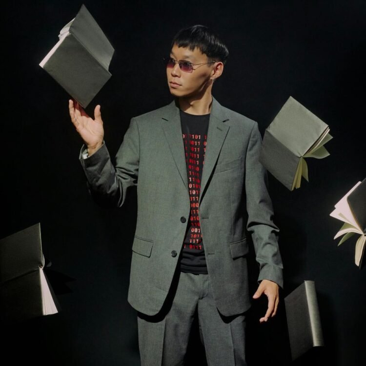 Man in Gray Suit Surround with Floating Black Books
