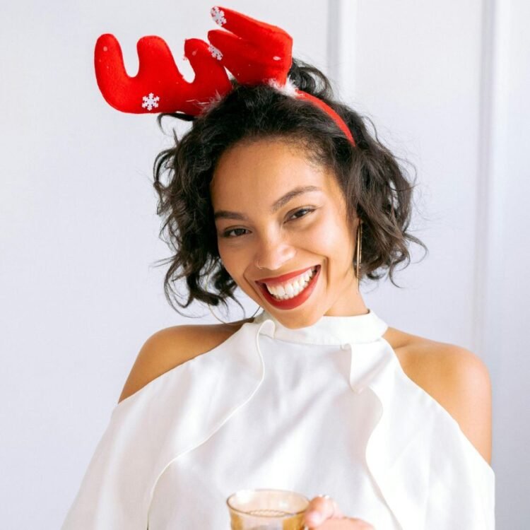 A Woman in White Dress Wearing a Reindeer Headband
