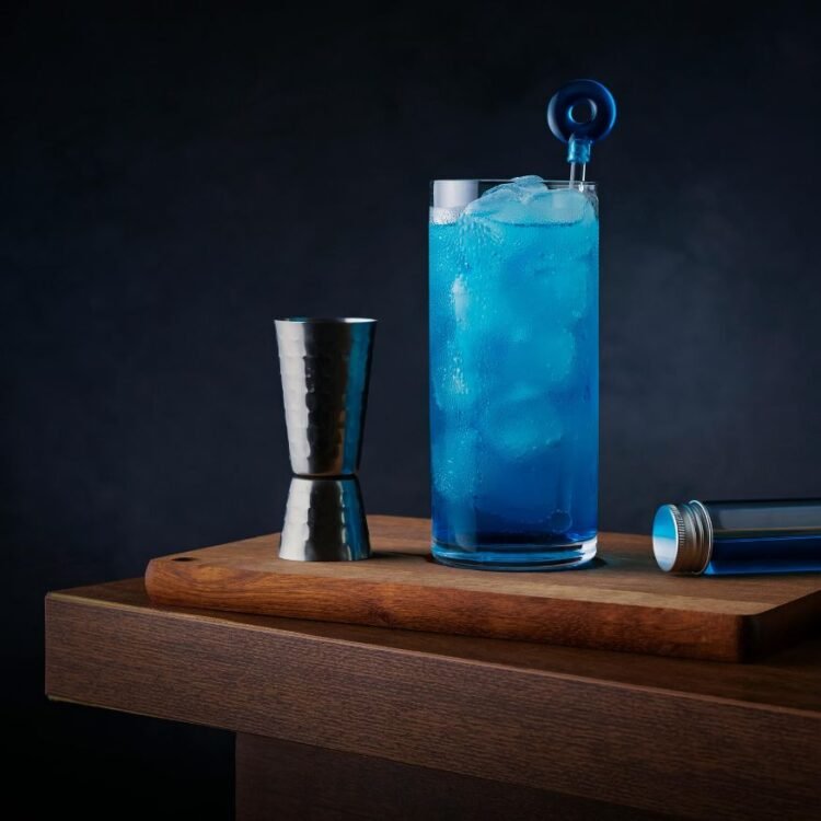 Vibrant Blue Cocktail with Bar Accessories
