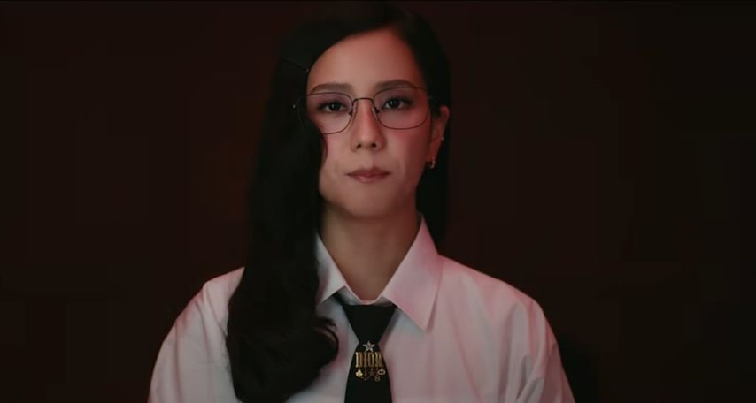 Jisoo in a white shirt, tie, and glasses