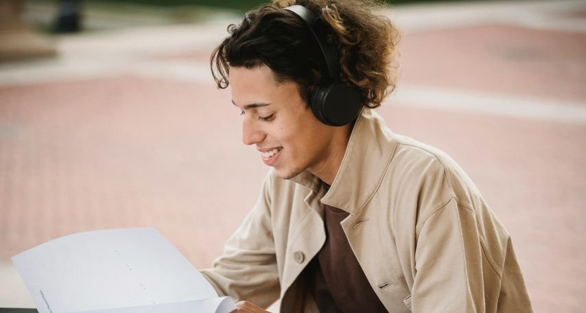 Student in a good mood listening to music and studying