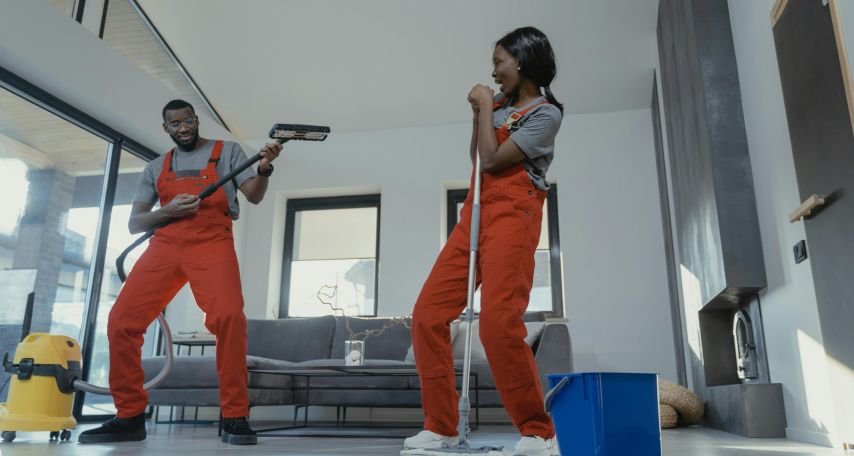 A Man and a Woman in Red Overalls having fun cleaning