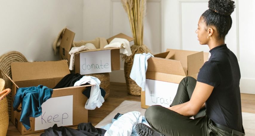 Woman Sitting on a Rug Sorting Clothes
