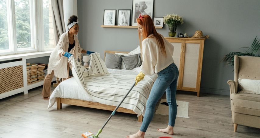Women Cleaning a Bedroom